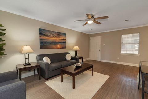 a living room with a couch and a ceiling fan